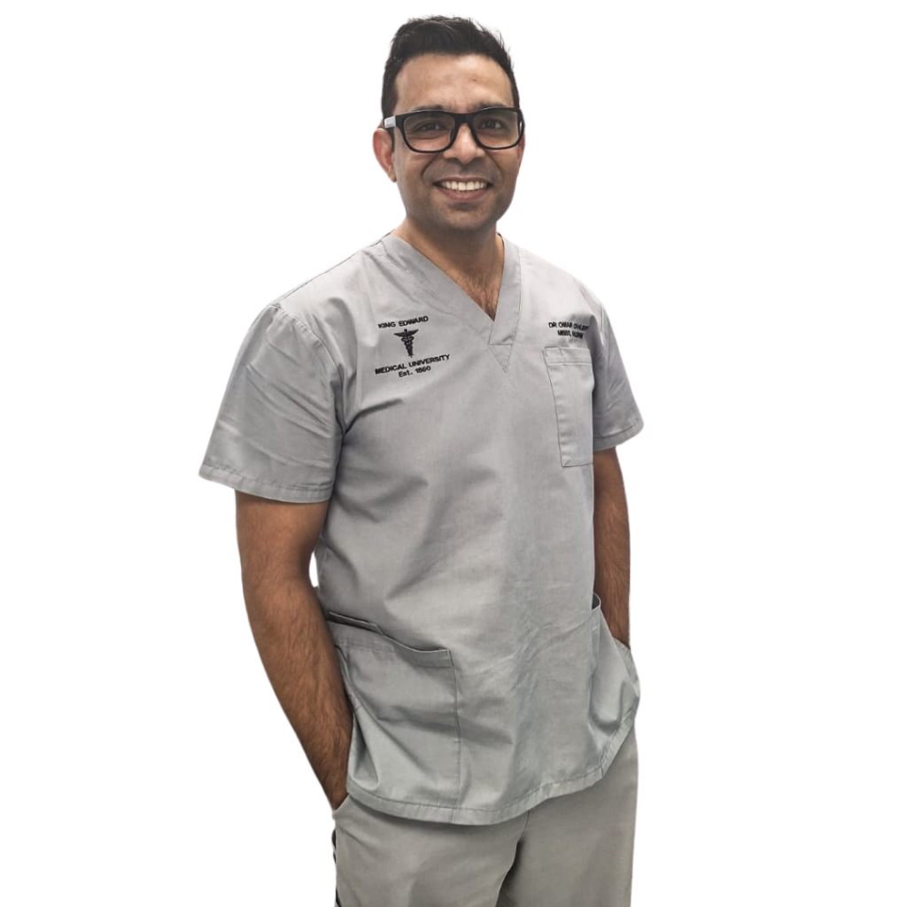 Dr Omair Chaudry smiling in clinical scrubs.