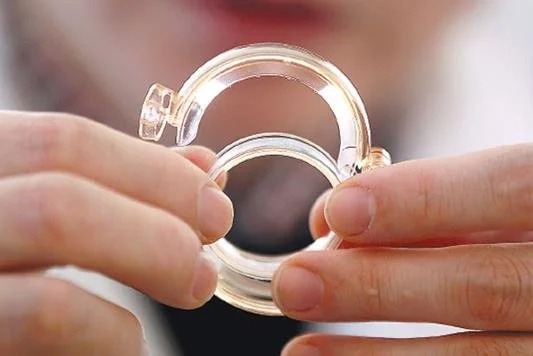 A clinician holding a Shang Ring medical device.